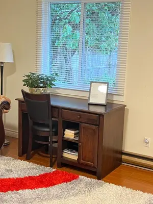 a desk with a laptop on it in front of a window at Vancouver shaughnessy guest home in Vancouver