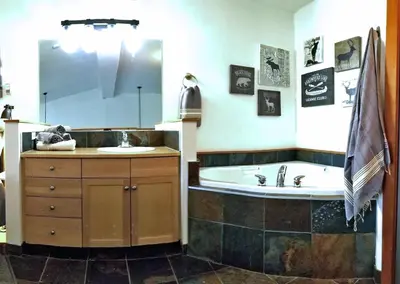 a bathroom with a tub and a sink at Downtown Loft, Mountain Views, Fireplace, Couple's Retreat, Walker's Paradise in Canmore