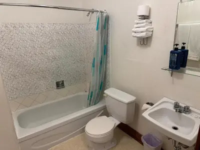 a bathroom with a toilet and a sink at Rodmay Hotel in Powell River