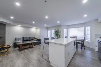 a kitchen and living room with a couch and a table at Private Vacation Guest Suite Near Beach in White Rock