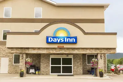 a days inn sign on the front of a building at Days Inn by Wyndham Chetwynd in Chetwynd
