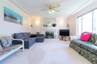 a living room with two couches and a tv at 3 Private, spacious, bright rooms in a Gorgeous house in New Westminster