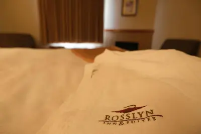 a white shirt with a roswin industries logo on it at Rosslyn Inn & Suites in Edmonton