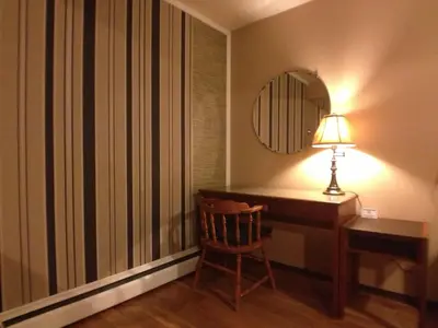 a desk with a lamp and a chair in a room at Galaxy Motel in St. Paul