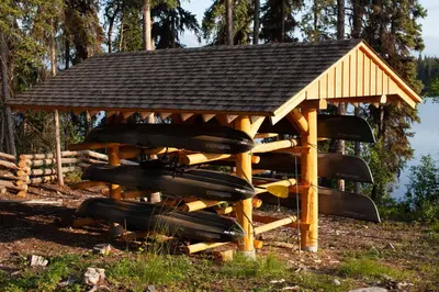 a wooden gazebo with a roof on top at Red Cariboo Apartments in Anahim Lake