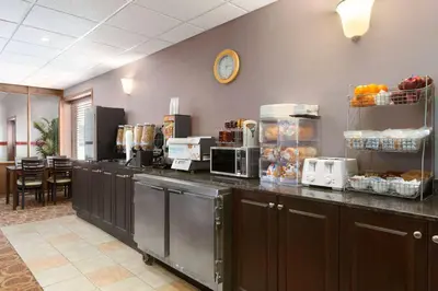 a kitchen with a counter top with food and appliances at Travelodge by Wyndham Meadow Lake in Meadow Lake