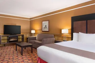 a hotel room with a bed and a television at Travelodge by Wyndham Meadow Lake in Meadow Lake