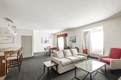 a living room with a couch and a table at Edgewater Hotel in Whitehorse