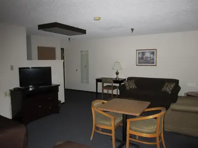 a living room with a couch and a table at Super 8 by Wyndham Williams Lake BC in Williams Lake