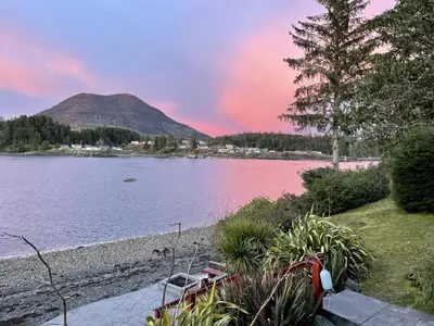a view of a lake with a mountain in the background at Waterfront Hot Tub Firepit King Bed - 6H in Ucluelet
