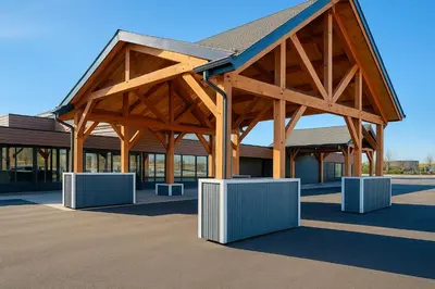 a large wooden pavilion in front of a building at Super 8 by Wyndham Spruce Grove in Spruce Grove