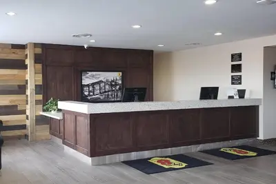 a lobby with a reception desk with a counter at Super 8 by Wyndham Spruce Grove in Spruce Grove
