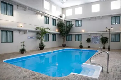 a pool in the courtyard of a hotel at Heritage Inn Hotel & Convention Centre - High River in High River
