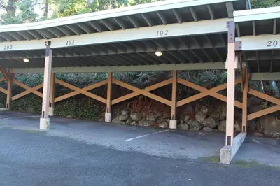 a parking lot with a building with a roof at Siennas Harbour House in Tofino
