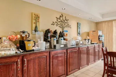 a kitchen with a counter with a bunch of appliances at Travelodge by Wyndham Nanaimo in Nanaimo