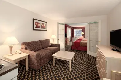 a hotel room with a couch and a bed at Travelodge by Wyndham Nanaimo in Nanaimo
