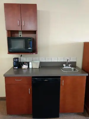 a kitchen with a sink and a microwave at Super 8 by Wyndham High Level AB in High Level