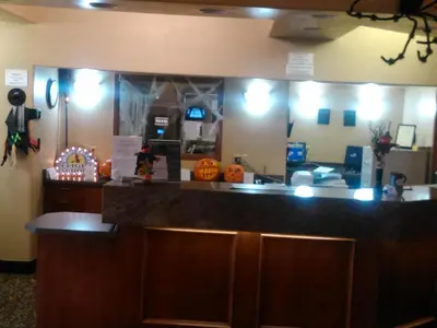 a restaurant with a counter with a pumpkin on it at Super 8 by Wyndham High Level AB in High Level