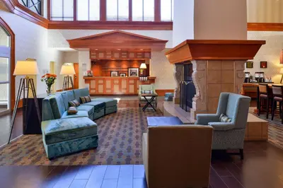 a living room with couches and a fireplace at Hampton Inn & Suites by Hilton Calgary University NW in Calgary