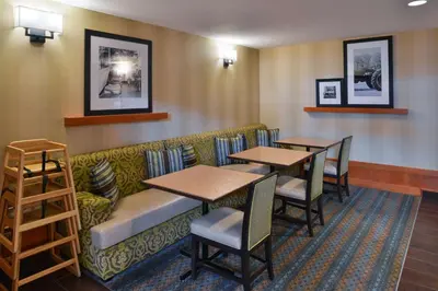 a waiting room with two tables and a couch at Hampton Inn & Suites by Hilton Calgary University NW in Calgary