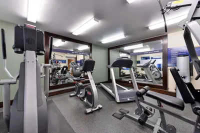 a gym with several tread machines and mirrors at Hampton Inn & Suites by Hilton Calgary University NW in Calgary