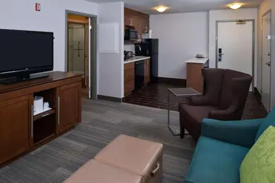 a living room with a couch and a flat screen tv at Hampton Inn & Suites by Hilton Calgary University NW in Calgary