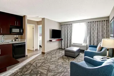 a hotel room with a kitchen and a living room at Hampton Inn & Suites by Hilton Calgary-Airport in Calgary