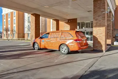 an orange van parked in front of a building at Hampton Inn & Suites by Hilton Calgary-Airport in Calgary