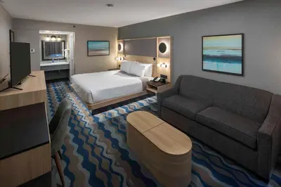 a hotel room with a bed and a couch at Accent Inns Burnaby in Burnaby