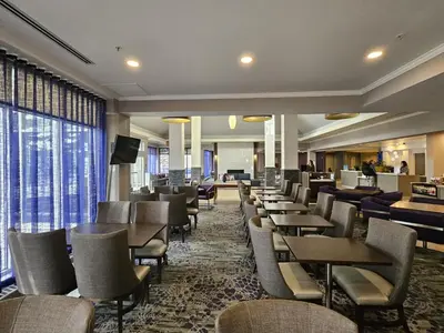 a dining room with tables and chairs in a hotel at Hilton Garden Inn Calgary Airport in Calgary
