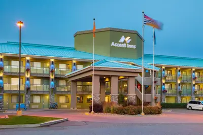 a hotel with a sign on the front of it at Accent Inns Kamloops in Kamloops