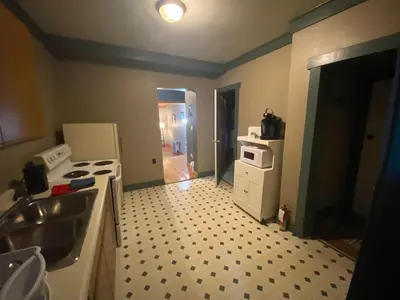 a kitchen with a sink and a stove top oven at Historic Hotel Bayview in Stewart