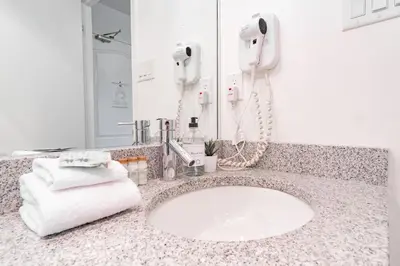 a bathroom with a sink with a phone and towels at Marquise by Outpost Whistler in Whistler