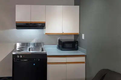 a small kitchen with a sink and a microwave at Accent Inns Victoria in Victoria