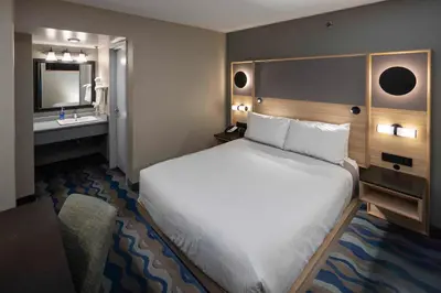 a hotel room with a bed and a sink at Accent Inns Victoria in Victoria