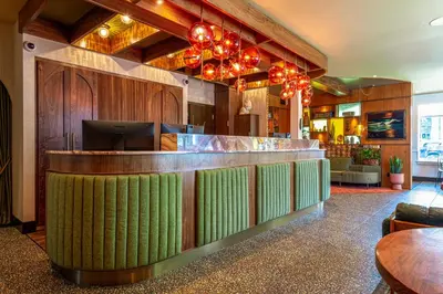 a lobby with a bar with green at Hotel Zed Victoria in Victoria