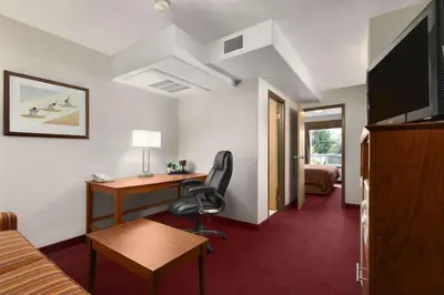 a hotel room with a desk and a chair at Super 8 by Wyndham Yellowknife in Yellowknife