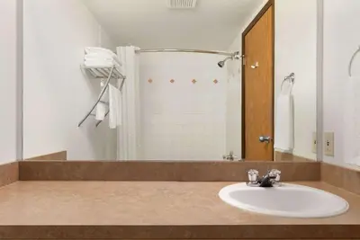 a bathroom with a sink and a shower at Super 8 by Wyndham Yellowknife in Yellowknife