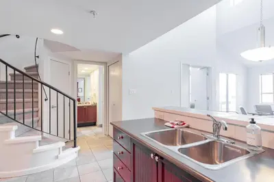 a kitchen with a sink and a staircase at Tyndall Stone by Outpost Whistler in Whistler