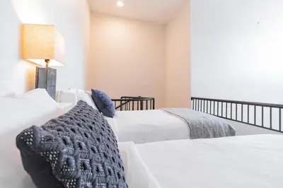 a bedroom with two beds and a lamp at Tyndall Stone by Outpost Whistler in Whistler