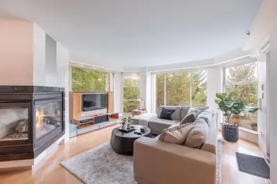 a living room with a couch and a fireplace at Woodrun by Outpost Whistler in Whistler