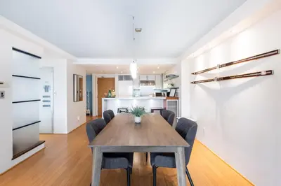 a dining room and kitchen with a table and chairs at Woodrun by Outpost Whistler in Whistler