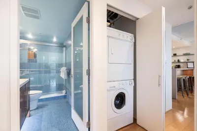 a laundry room with a washer and dryer at Woodrun by Outpost Whistler in Whistler