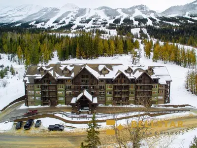 a large building with snow on top of a mountain at Palliser Lodge — Bellstar Hotels & Resorts in Golden