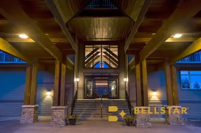 a lobby of a building with a staircase and a window at Palliser Lodge — Bellstar Hotels & Resorts in Golden