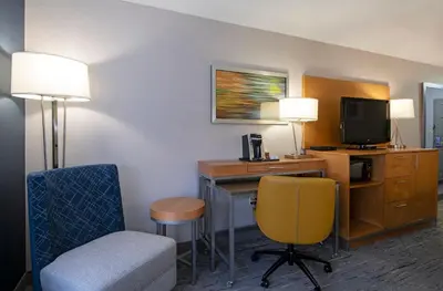 a hotel room with a desk with a tv and a chair at Holiday Inn Express Kamloops by IHG in Kamloops