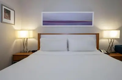 a bedroom with a white bed with two lamps at Holiday Inn Express Kamloops by IHG in Kamloops