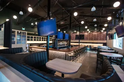 a restaurant with a bar with chairs and tables at Four Points by Sheraton Edmonton Gateway in Edmonton