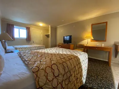 a hotel room with two beds and a television at Aspen Motor Inn in Drayton Valley