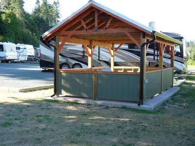 a pavilion with a boat parked in a parking lot at Driftwood by the Sea Inn in Campbell River